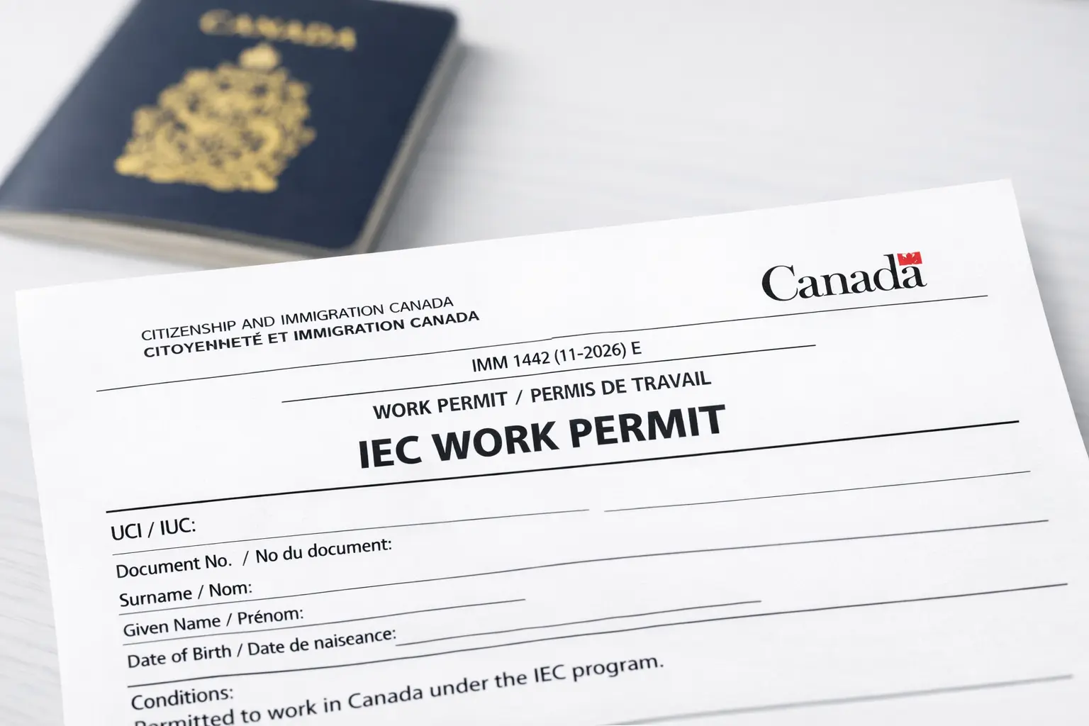 A Canadian IEC Work Permit (IMM 1442) document sitting next to a passport, representing the 2026 extension policy.
